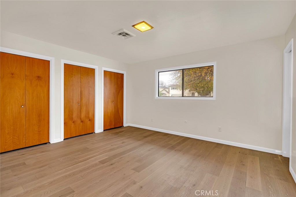 358 Sycamore Avenue Gustine, CA 95322 - Photo 15 of 37 a view of an empty room with wooden floor and a window