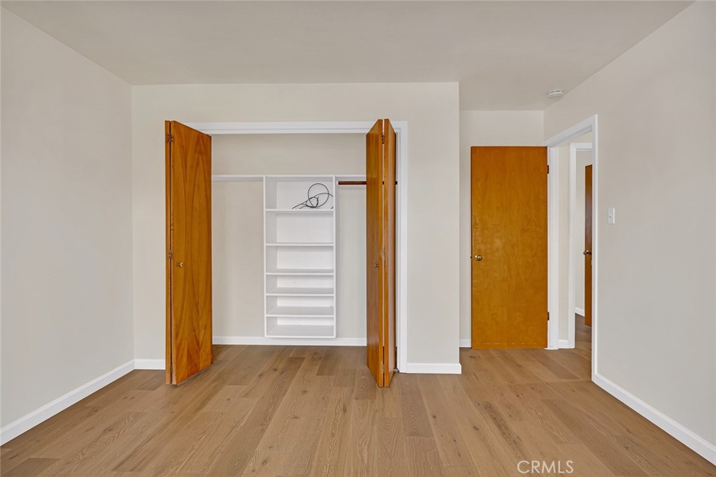 358 Sycamore Avenue Gustine, CA 95322 - Photo 19 of 37 an empty room with closet and wooden floor
