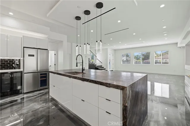 a kitchen with stainless steel appliances granite countertop a refrigerator and a stove