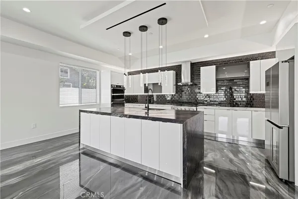 a kitchen with stainless steel appliances granite countertop a sink stove and cabinets