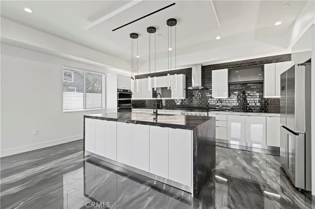 a kitchen with stainless steel appliances granite countertop a sink stove and cabinets