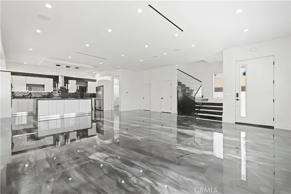 a kitchen with stainless steel appliances granite countertop a sink and a refrigerator