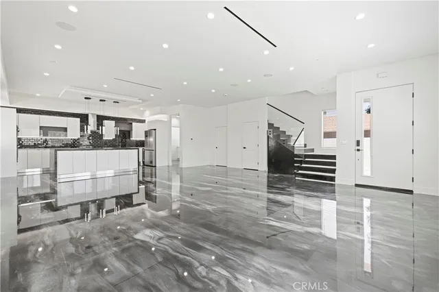 a kitchen with stainless steel appliances granite countertop a sink and a refrigerator