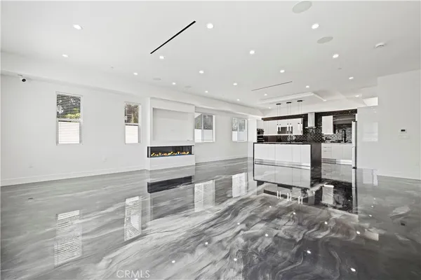 a kitchen with stainless steel appliances granite countertop a sink a refrigerator and a stove