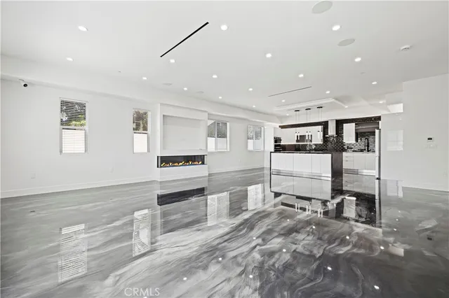 a kitchen with stainless steel appliances granite countertop a sink a refrigerator and a stove