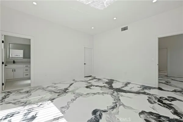 a view of a livingroom with wooden floor and a sink