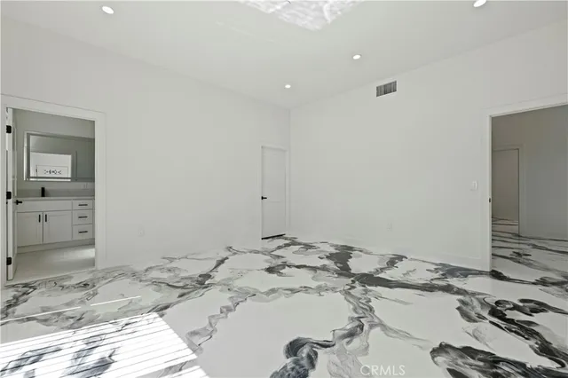 a view of a livingroom with wooden floor and a sink