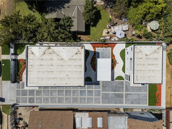 an aerial view of a residential apartment building with a yard