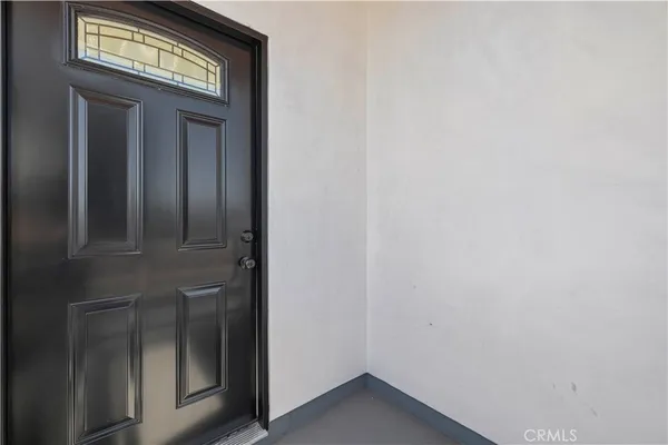 a view of a bedroom with bed and mirror