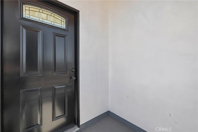a view of a bedroom with bed and mirror