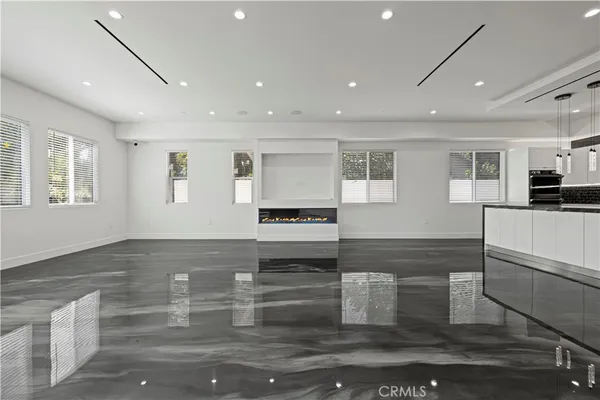 a kitchen with stainless steel appliances granite countertop a sink and a refrigerator