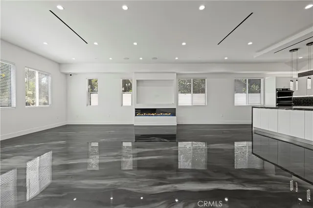 a kitchen with stainless steel appliances granite countertop a sink and a refrigerator