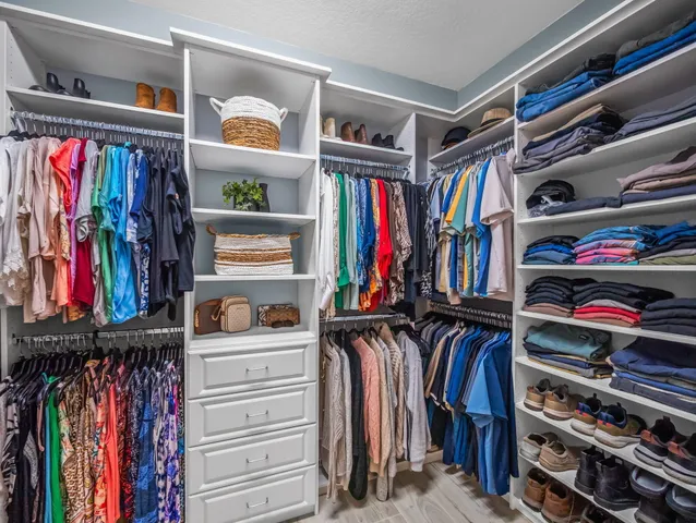 a bathroom with a granite countertop sink a mirror and shower