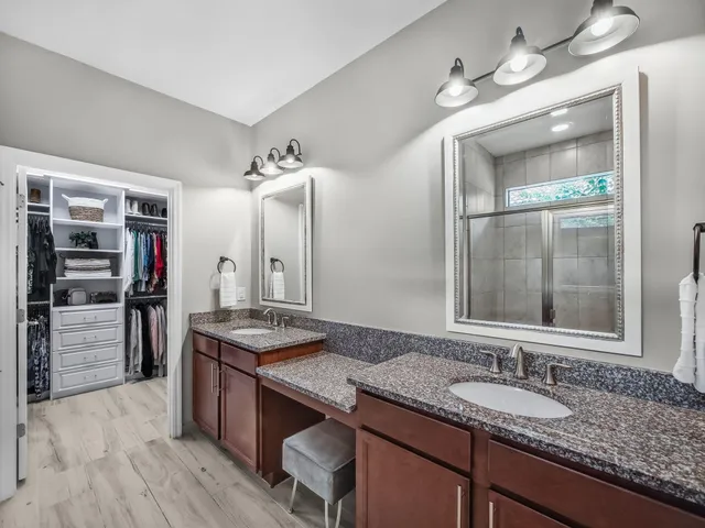 a bedroom with a bed and a table in it with wooden floor