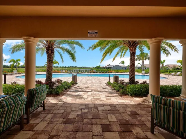 a swimming pool with outdoor seating