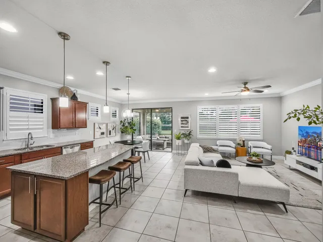 a large kitchen with granite countertop lots of counter space and stainless steel appliances