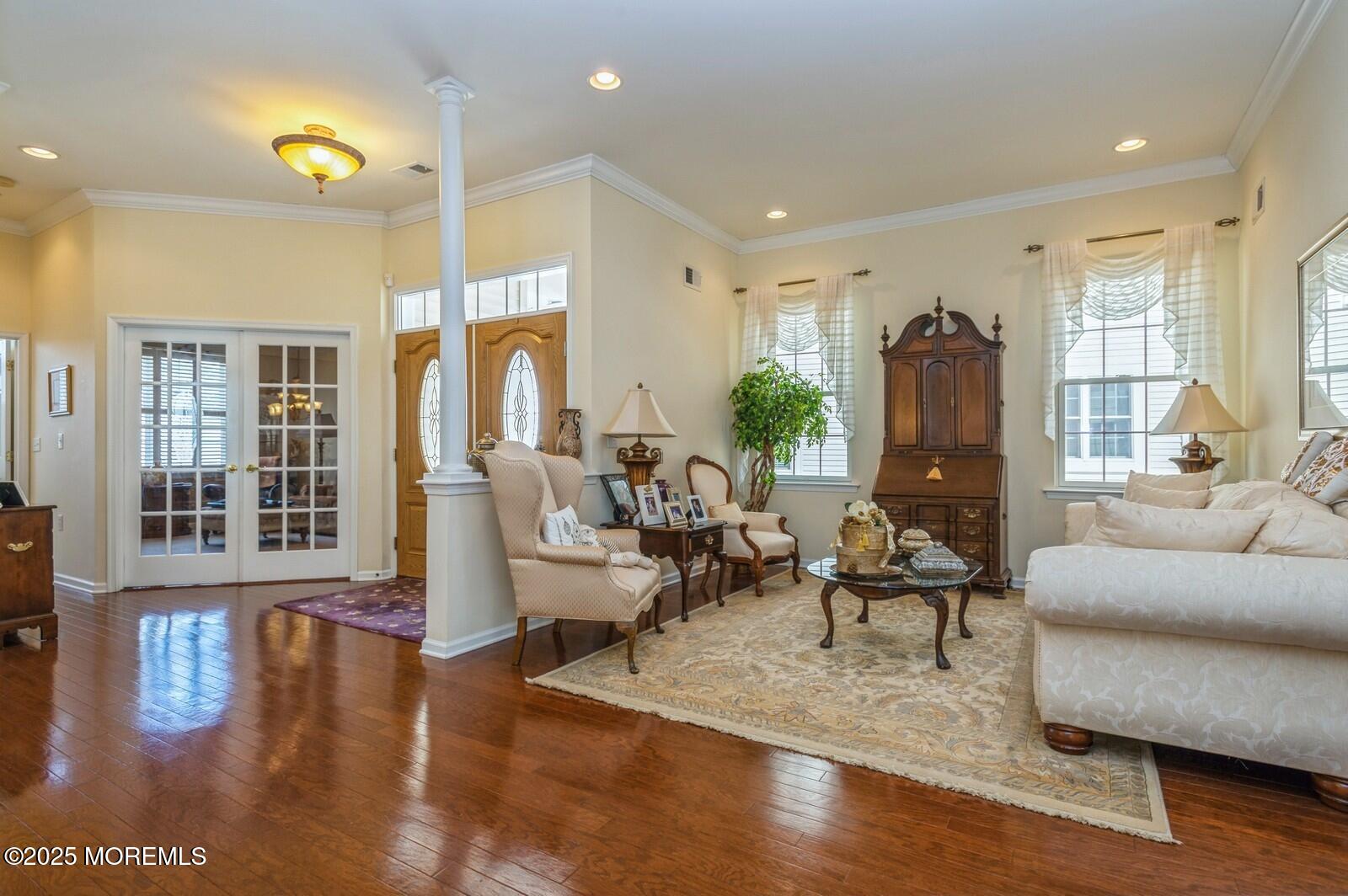 15 Eagleswood Drive Waretown, NJ 08758 - Photo 7 of 27 a living room with furniture and a chandelier