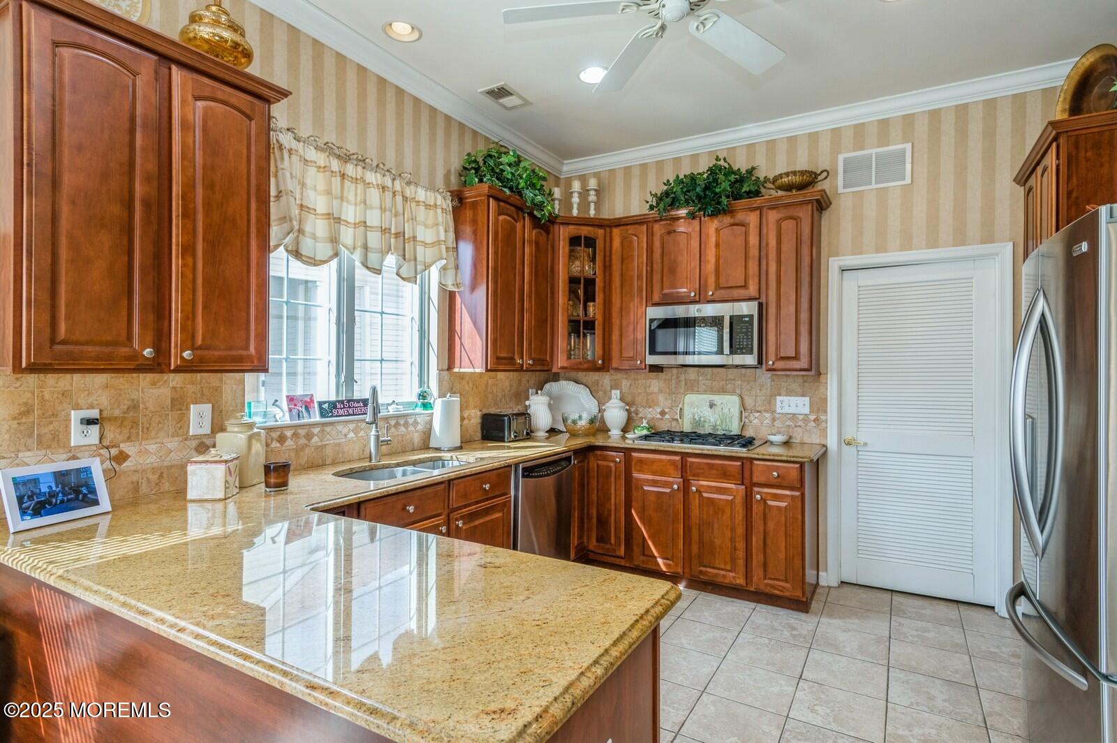 15 Eagleswood Drive Waretown, NJ 08758 - Photo 8 of 27 a kitchen with stainless steel appliances granite countertop a sink a refrigerator and a granite counter tops