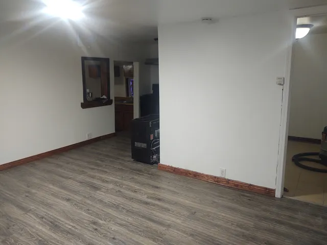 an empty room with wooden floor and closet