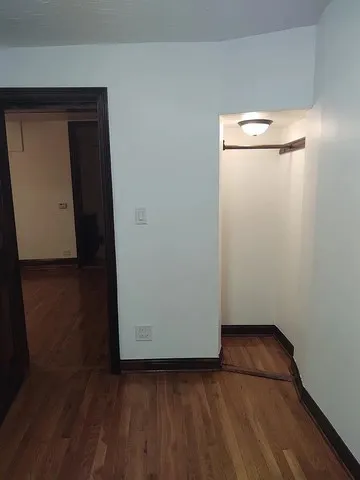 a view of a brick house with a door and wooden floor