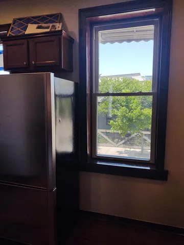 an entryway in a room with a chandelier fan