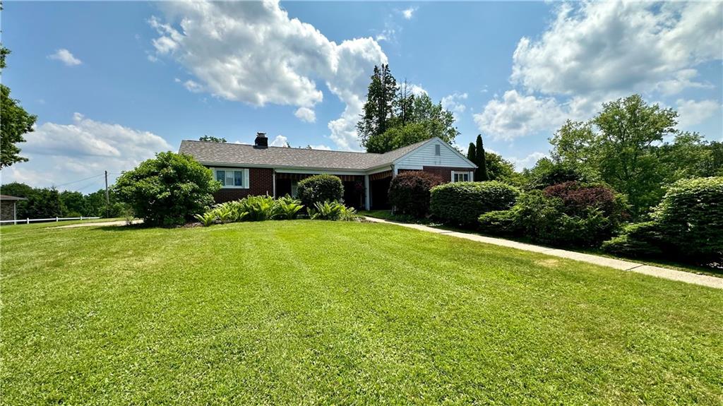 a front view of a house with garden