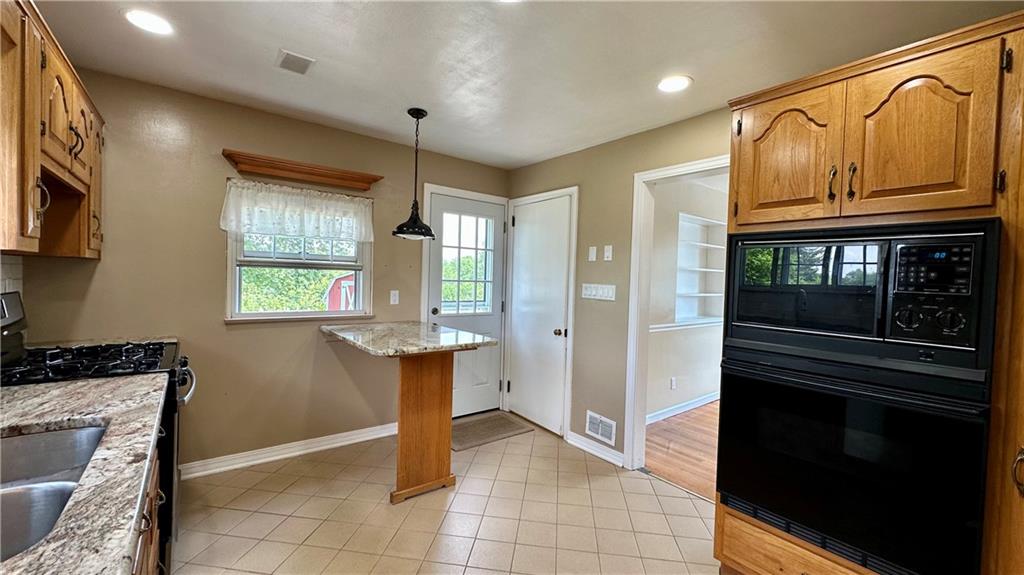 2231 Dellenbaugh Road Tarentum, PA 15084 - Photo 25 of 50 a kitchen with stainless steel appliances granite countertop a refrigerator and a stove top oven