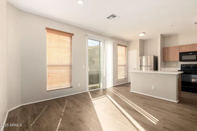 a view of a kitchen with wooden floor and a sink