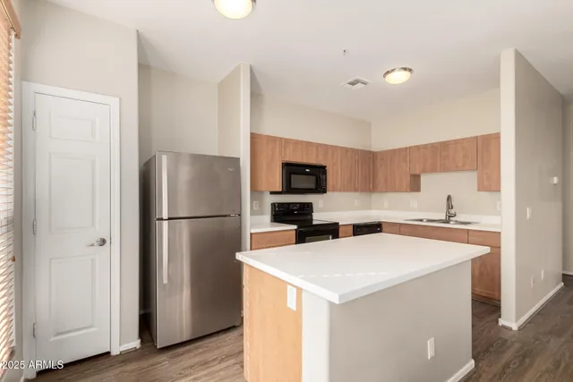 a kitchen with a refrigerator a stove and a microwave