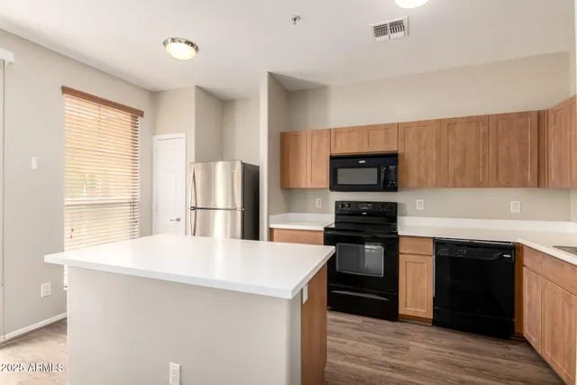 a kitchen with stainless steel appliances a stove microwave and refrigerator
