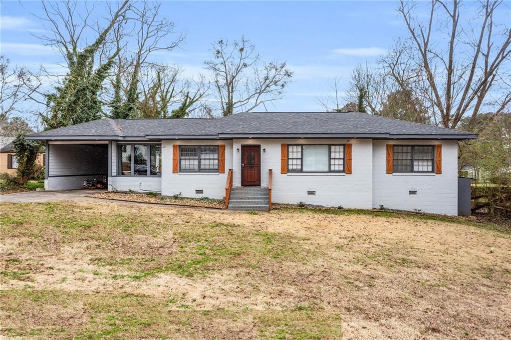 1674 Sandtown Road Southwest Atlanta, GA 30311 - Photo 1 of 1 a front view of a house with a yard