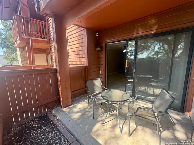 a backyard of a house with table and chairs