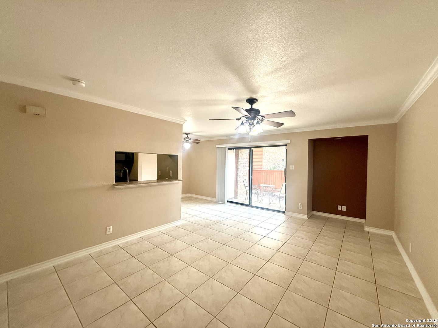 13018 Heimer, Unit 703 San Antonio, TX 78216 - Photo 6 of 28 a view of an empty room with window and chandelier fan
