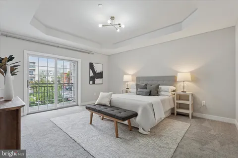 a bedroom with a bed and a large window