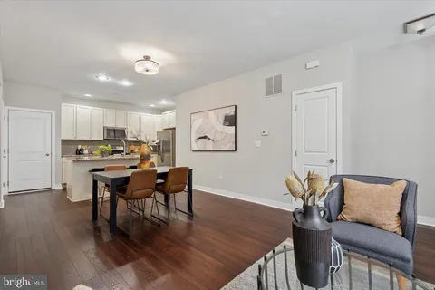 a view of a dining room with furniture and wooden floor