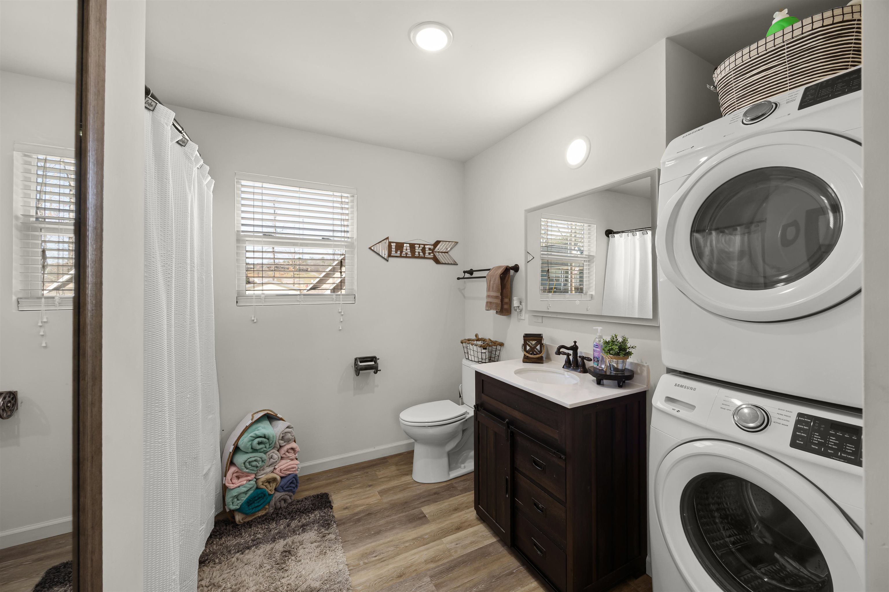 15 Bogey Loop Counce, TN 38326 - Photo 12 of 17 Washroom featuring stacked washer and dryer, a sink, laundry area, baseboards, and light wood-style floors