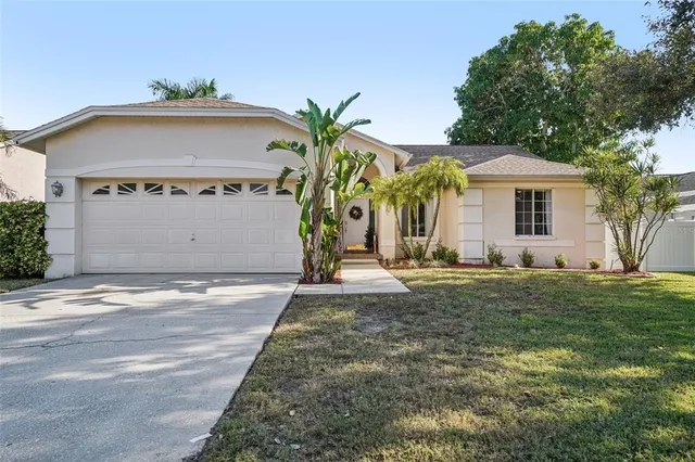 a view of a house with a yard and garage