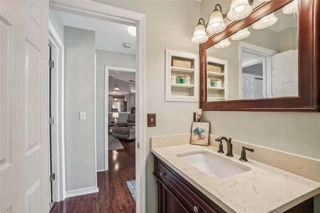 a bathroom with a sink toilet vanity and shower