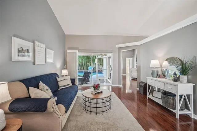 a living room with fireplace furniture and a wooden floor