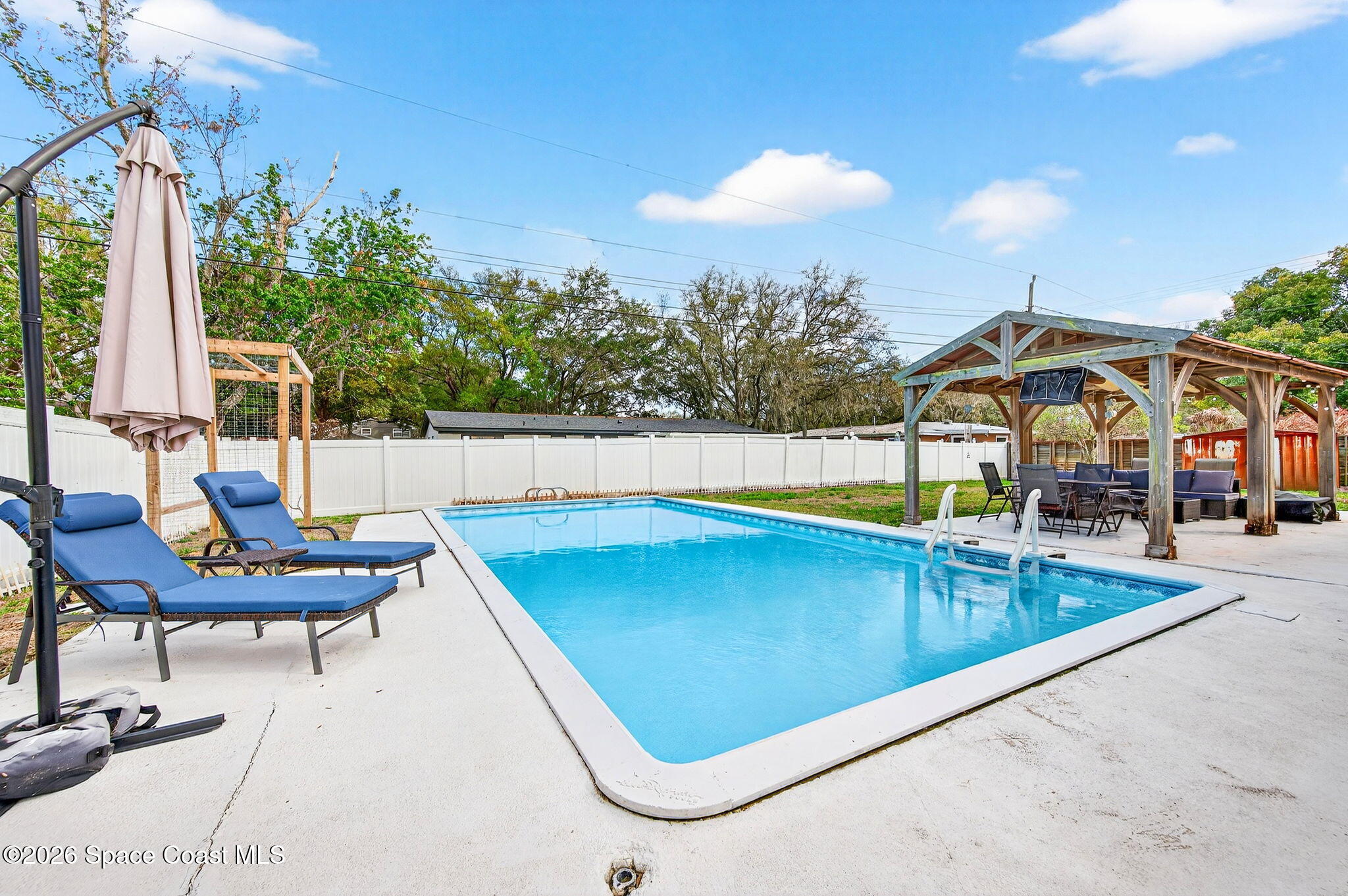 1857 North Carpenter Road Titusville, FL 32796 - Photo 21 of 51 a view of a swimming pool with lounge chairs