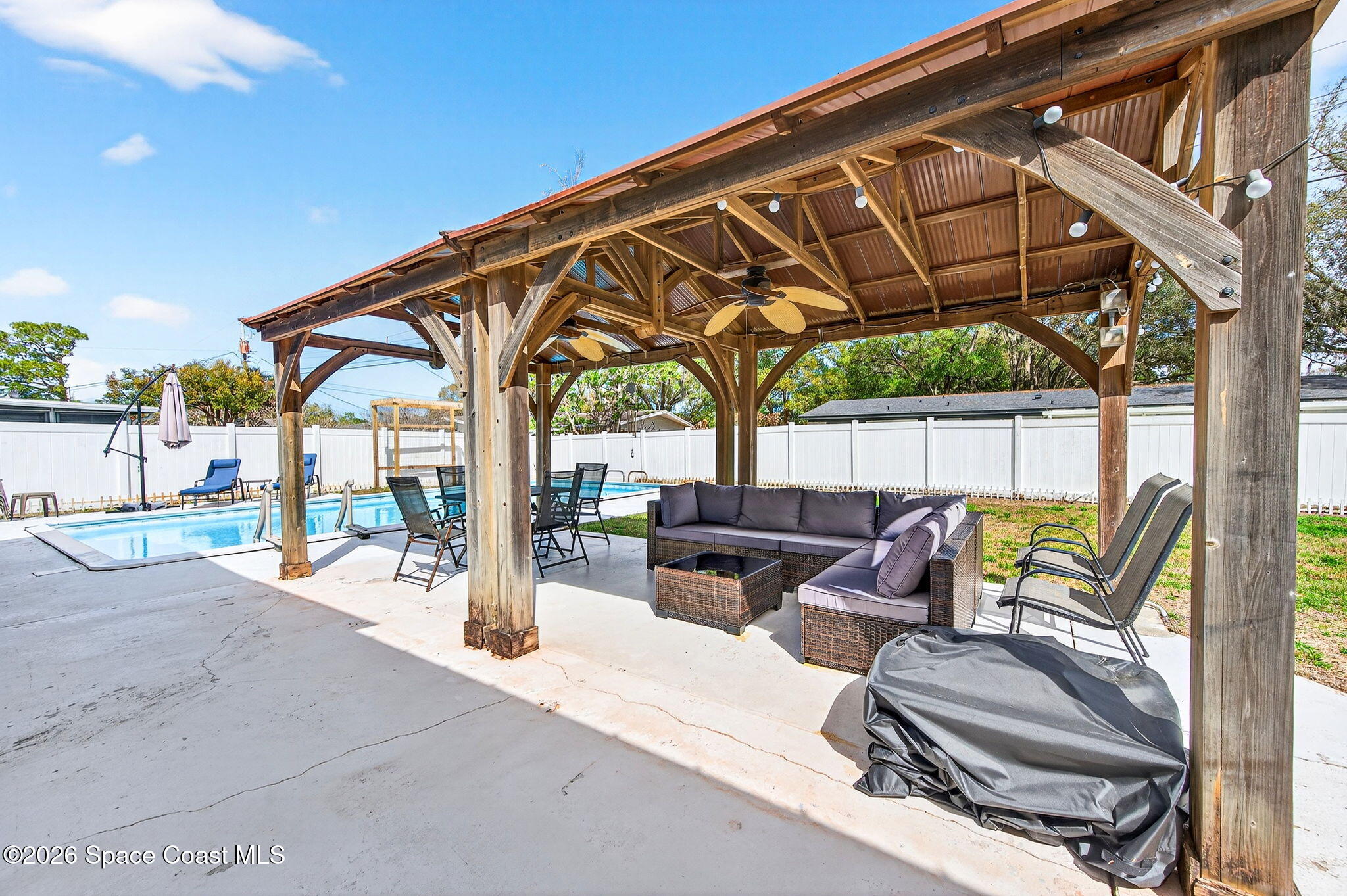 1857 North Carpenter Road Titusville, FL 32796 - Photo 25 of 51 a backyard of a house with table and chairs