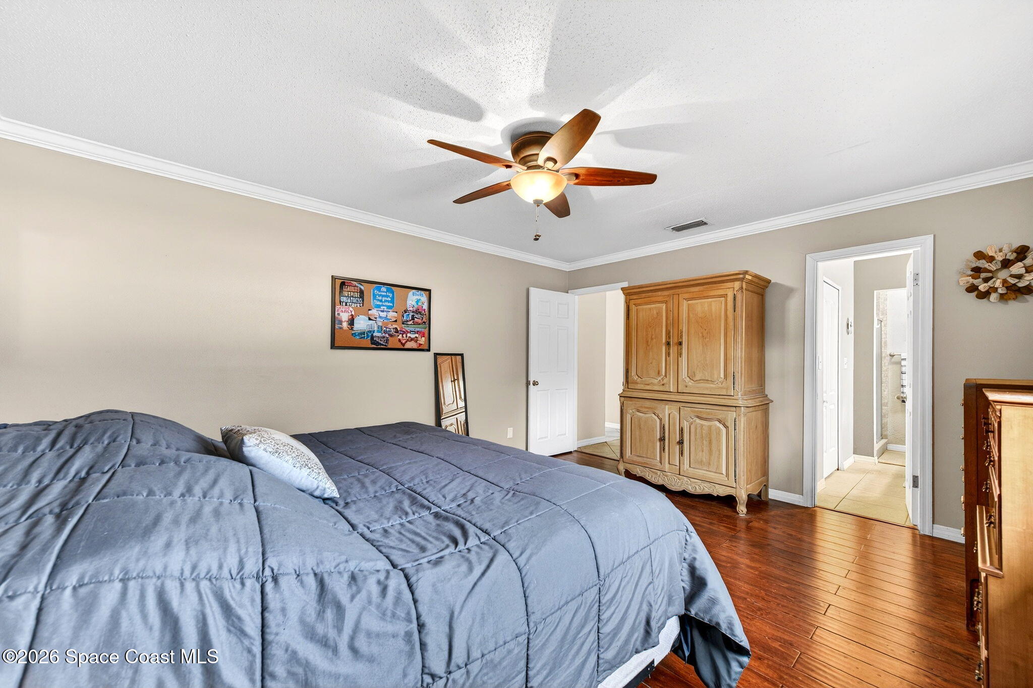 1857 North Carpenter Road Titusville, FL 32796 - Photo 37 of 51 a bedroom with a bed and a chandelier