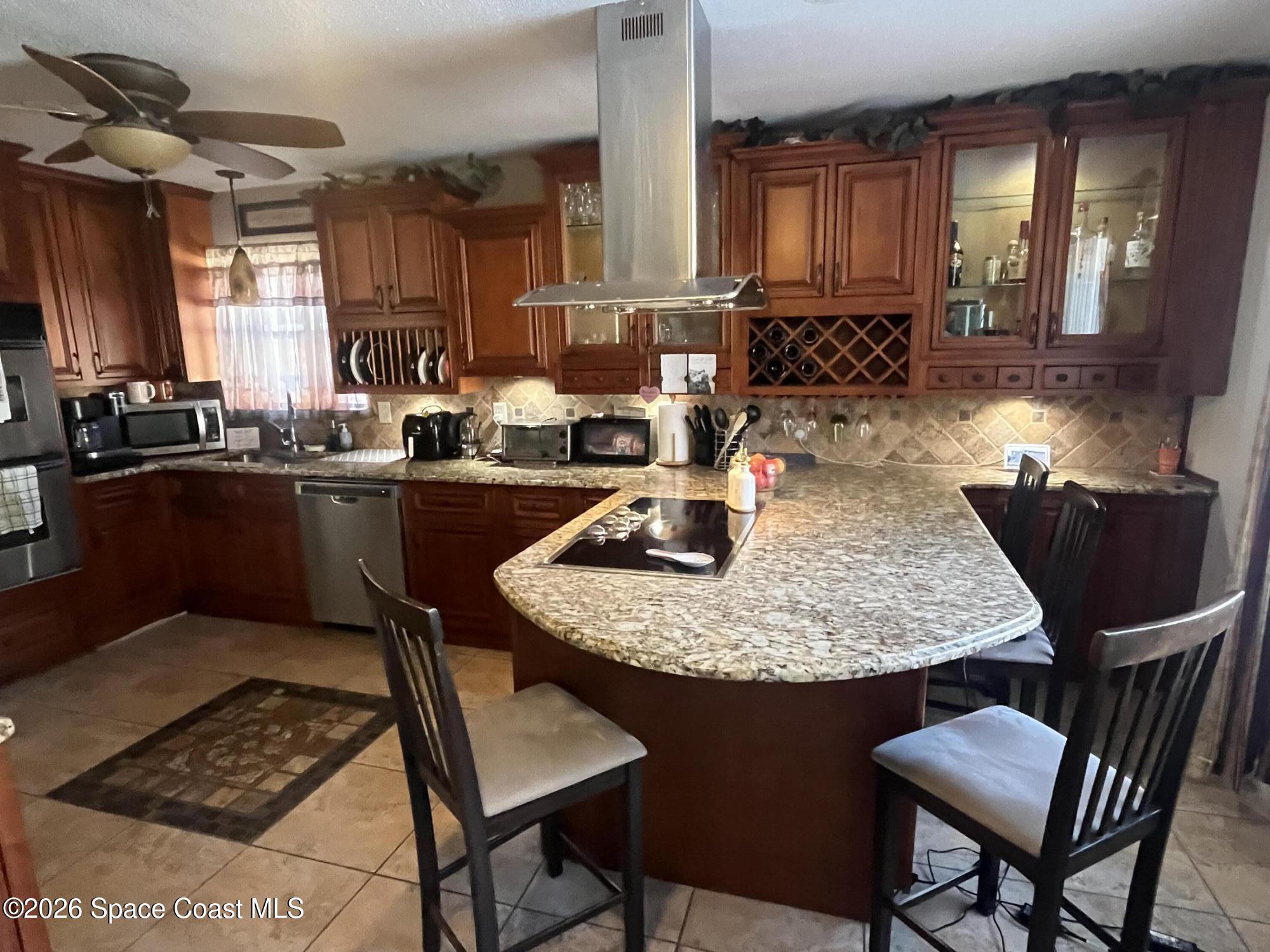 1857 North Carpenter Road Titusville, FL 32796 - Photo 41 of 51 a kitchen with sink a stove and chairs
