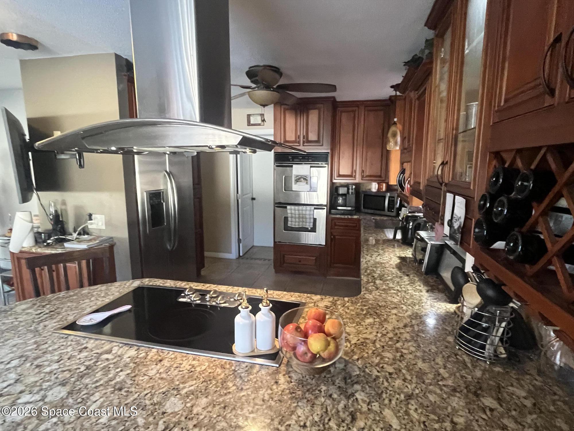 1857 North Carpenter Road Titusville, FL 32796 - Photo 42 of 51 a kitchen with stainless steel appliances granite countertop a sink a stove and a refrigerator