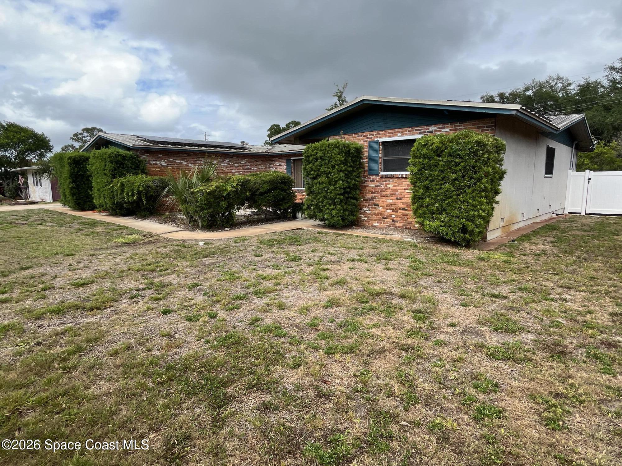 1857 North Carpenter Road Titusville, FL 32796 - Photo 50 of 51 a view of a house with a yard