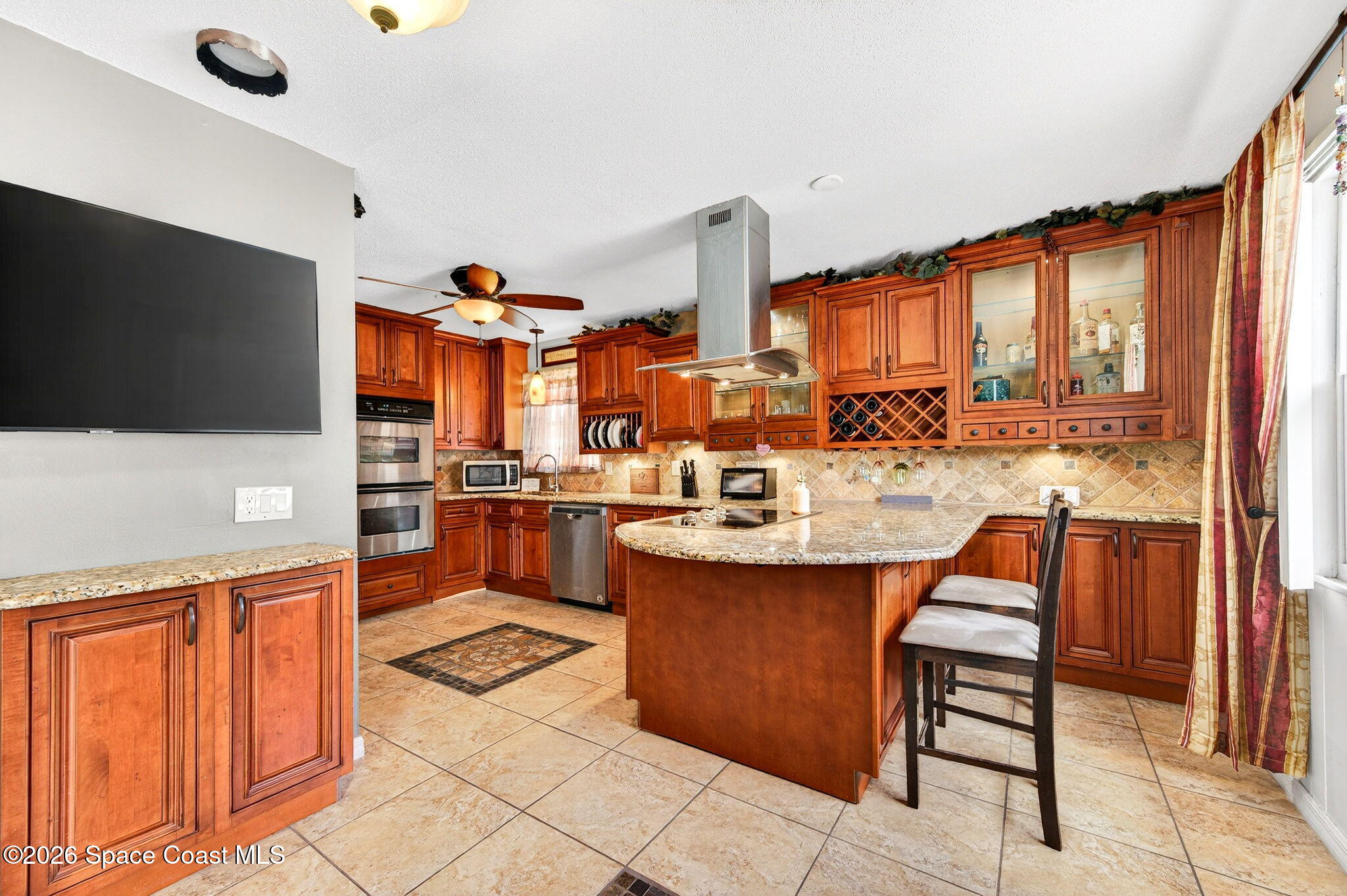 1857 North Carpenter Road Titusville, FL 32796 - Photo 7 of 51 a kitchen with stainless steel appliances kitchen island granite countertop a sink and cabinets