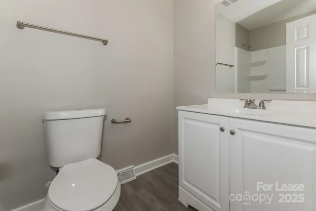 a white toilet sitting next to a bathroom sink
