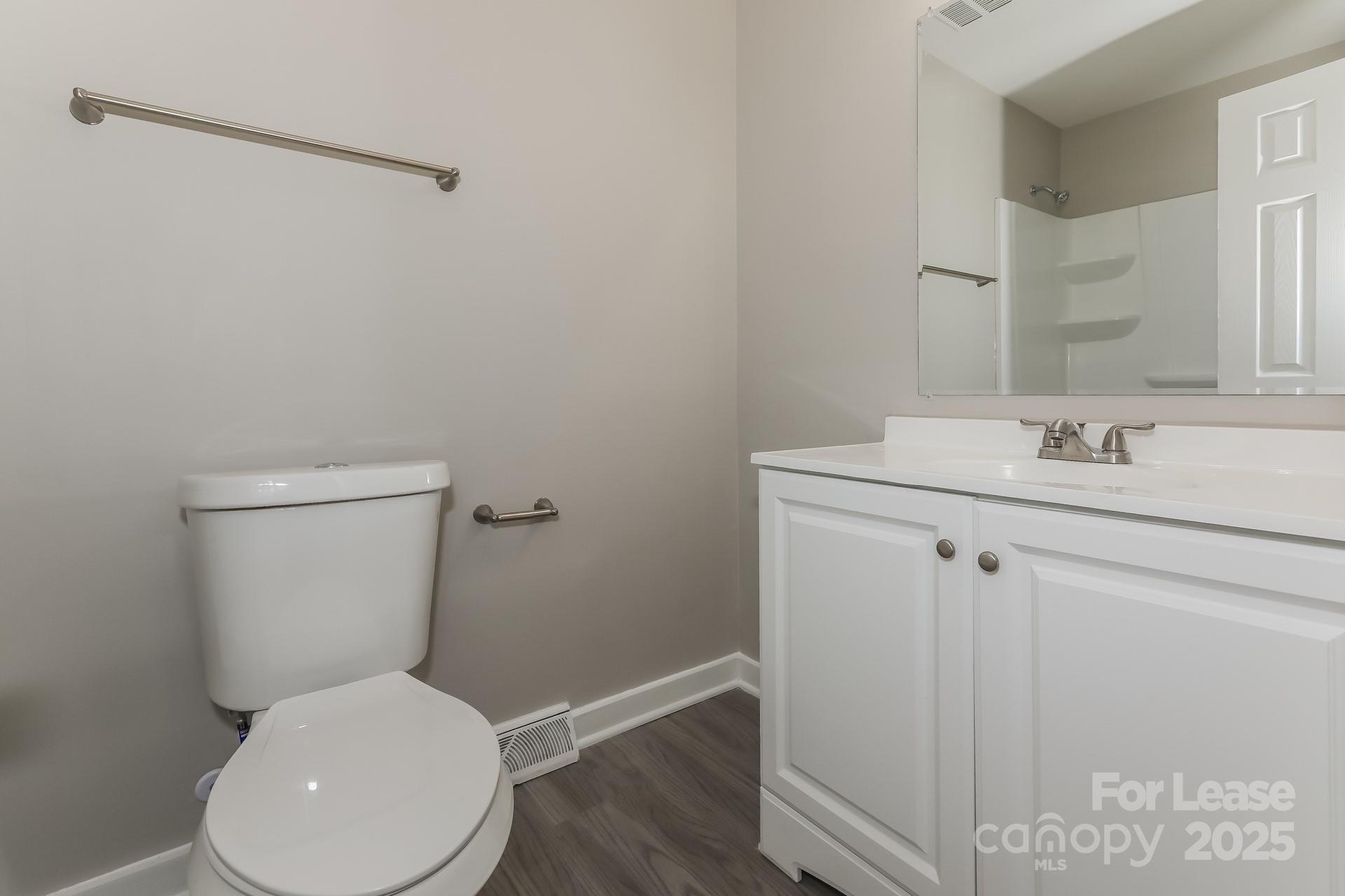 319 Cedarwood Lane Matthews, NC 28104 - Photo 13 of 16 a white toilet sitting next to a bathroom sink