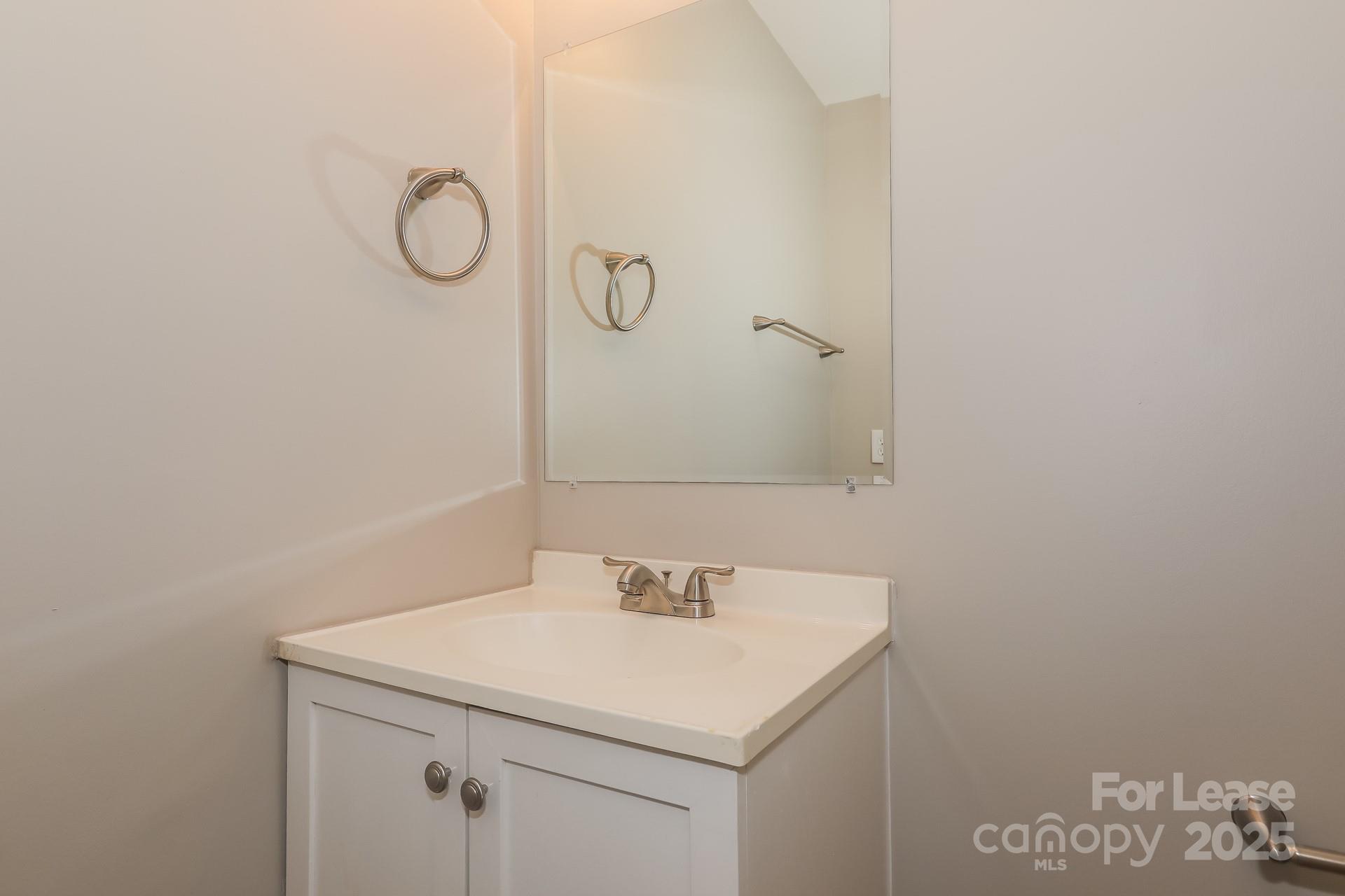 319 Cedarwood Lane Matthews, NC 28104 - Photo 14 of 16 a bathroom with a sink and a mirror