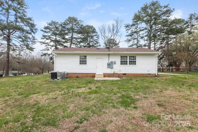 a front view of house with yard and trees